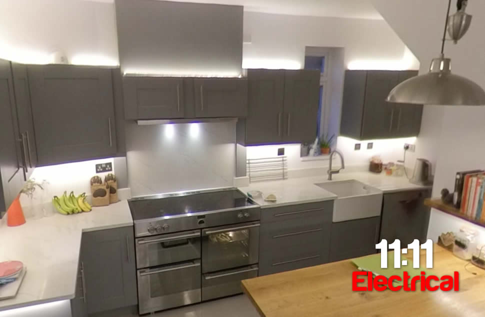 Grey Kitchen with LED strip light above units and below wall units, white quartz worktop, oak worktop, grey shaker doors